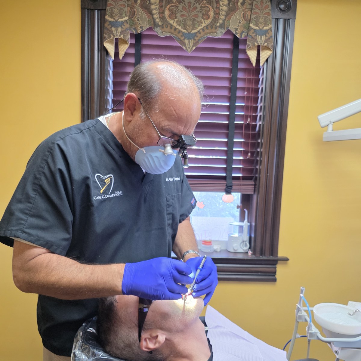 North Andover dentist checking a patient's mouth during an oral cancer screening